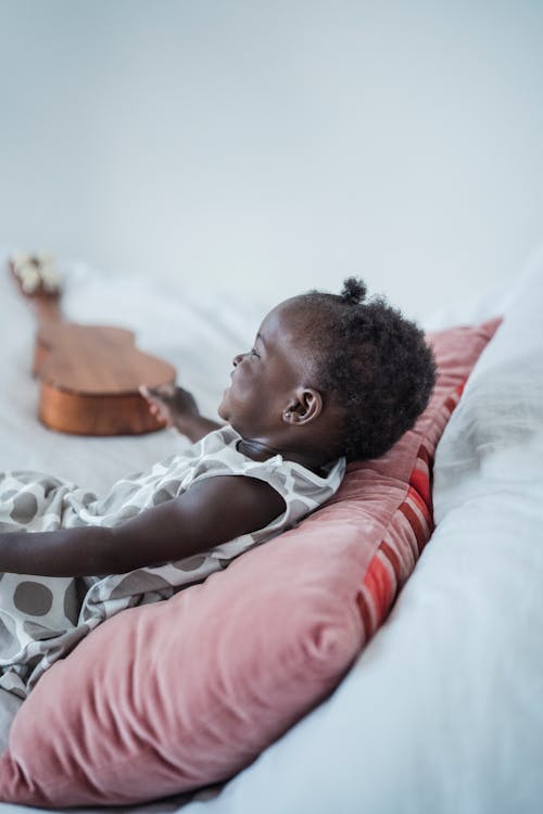 Free Child Lying Down on Pillow Stock Photo