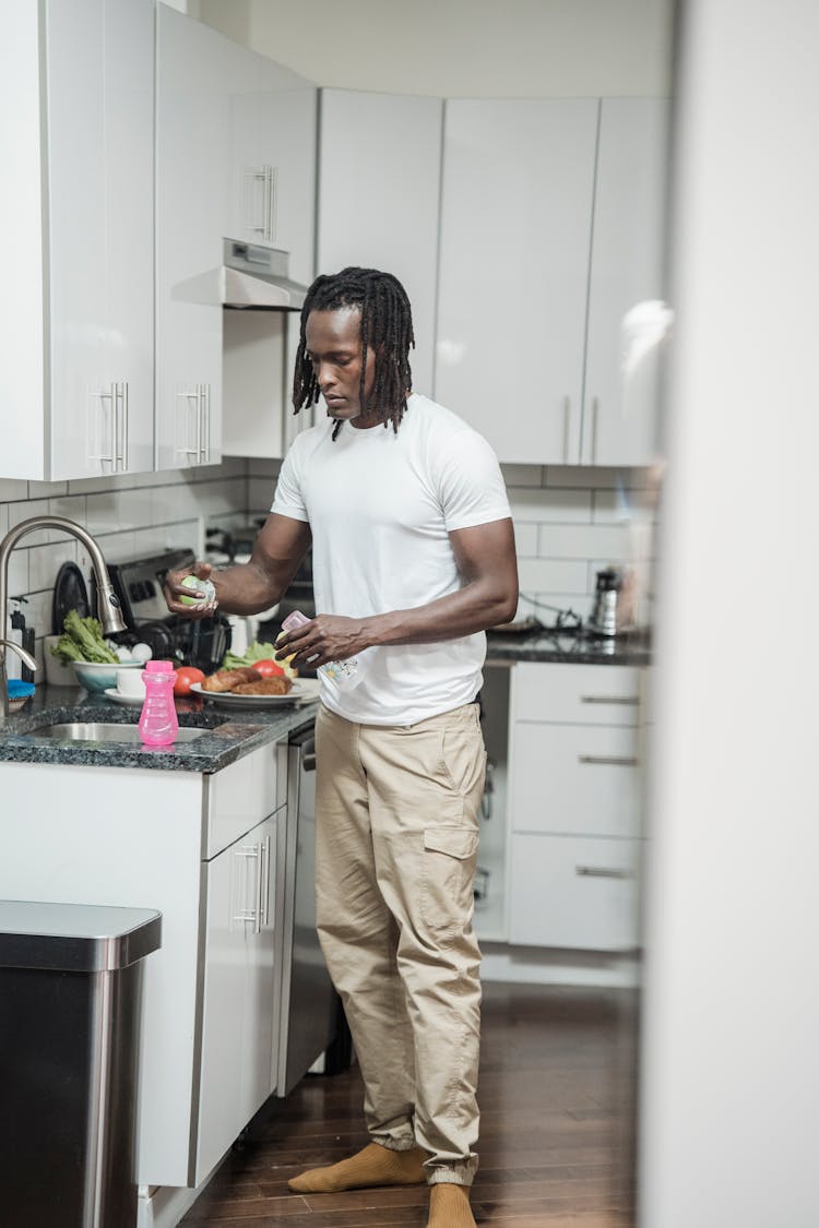 Man Preparing A Meal In The Kitchen 