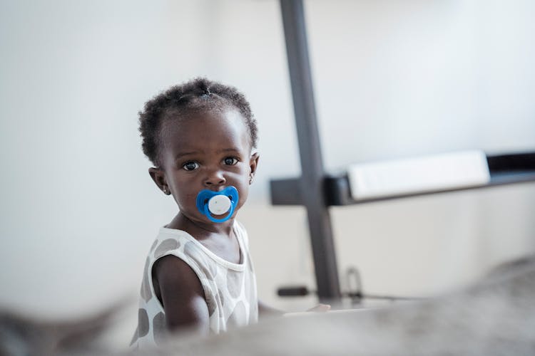 Cute Baby Girl With A Dummy In Her Mouth 