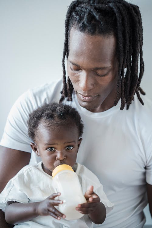 Free A Man Feeding Her Daughter Stock Photo