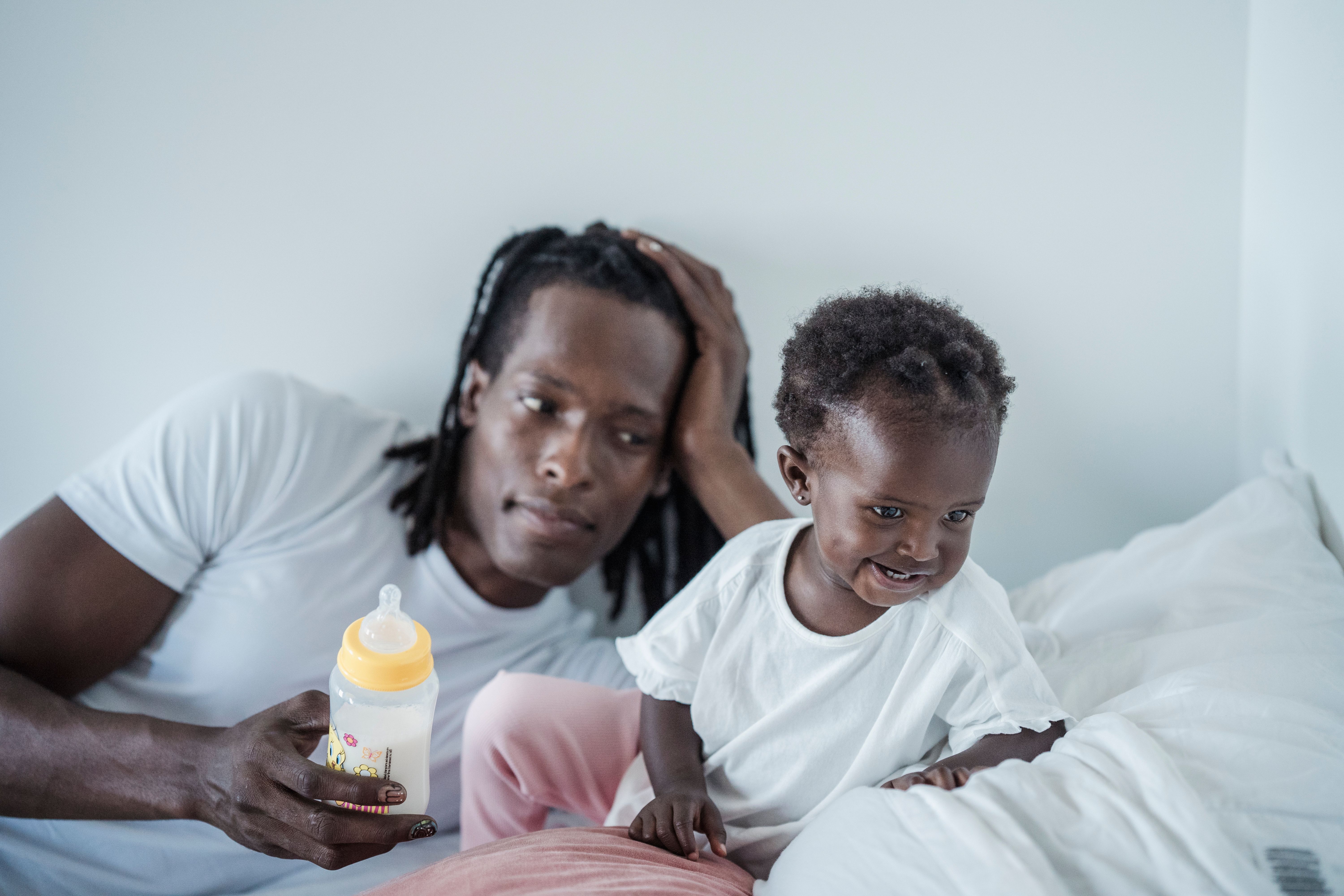 Father and daughter sharing a loving moment in a cozy indoor setting.