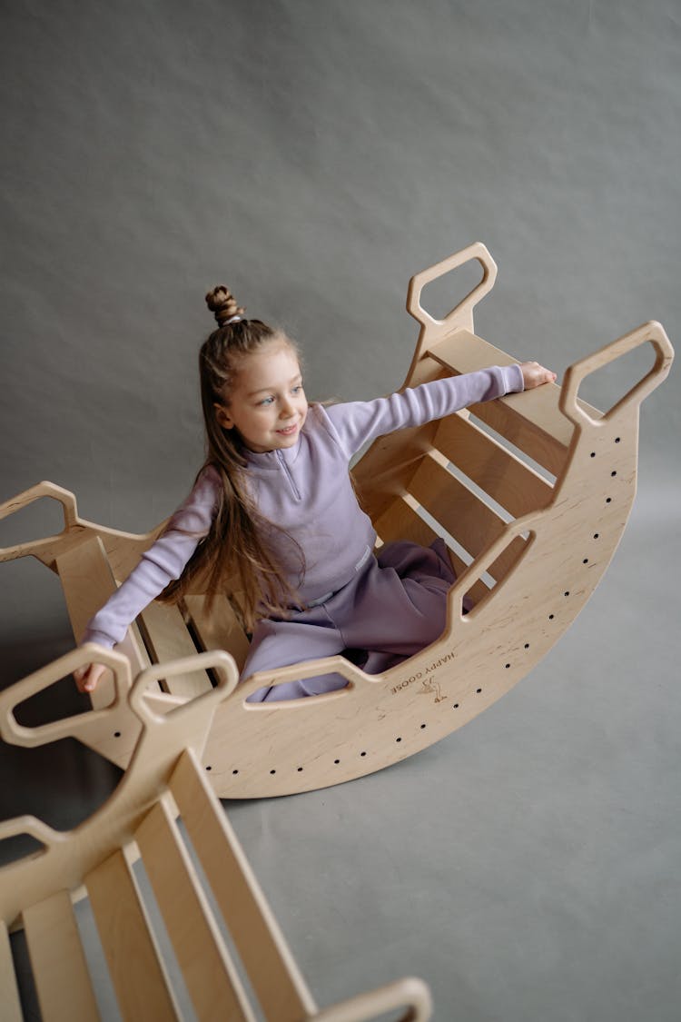 A Girl Sitting On A Double Rocker