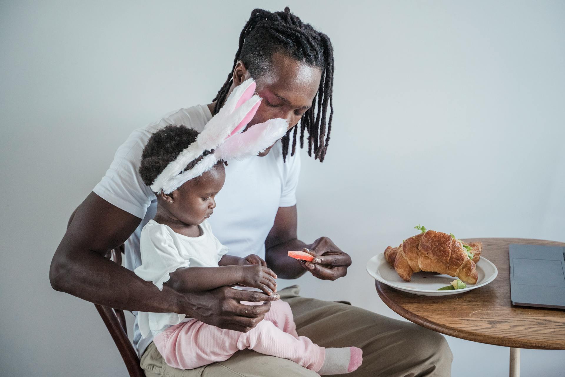 A Father Giving His Child a Piece of Candy