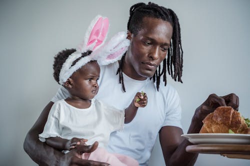 Free Man Carrying a Child Stock Photo