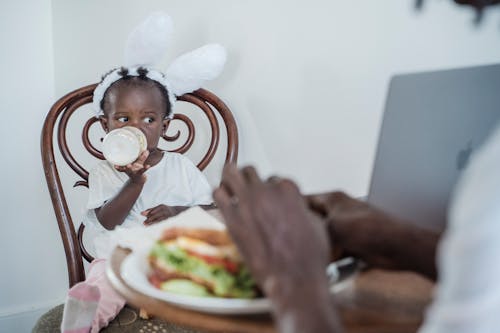 A Child Drinking Milk From a Bottle