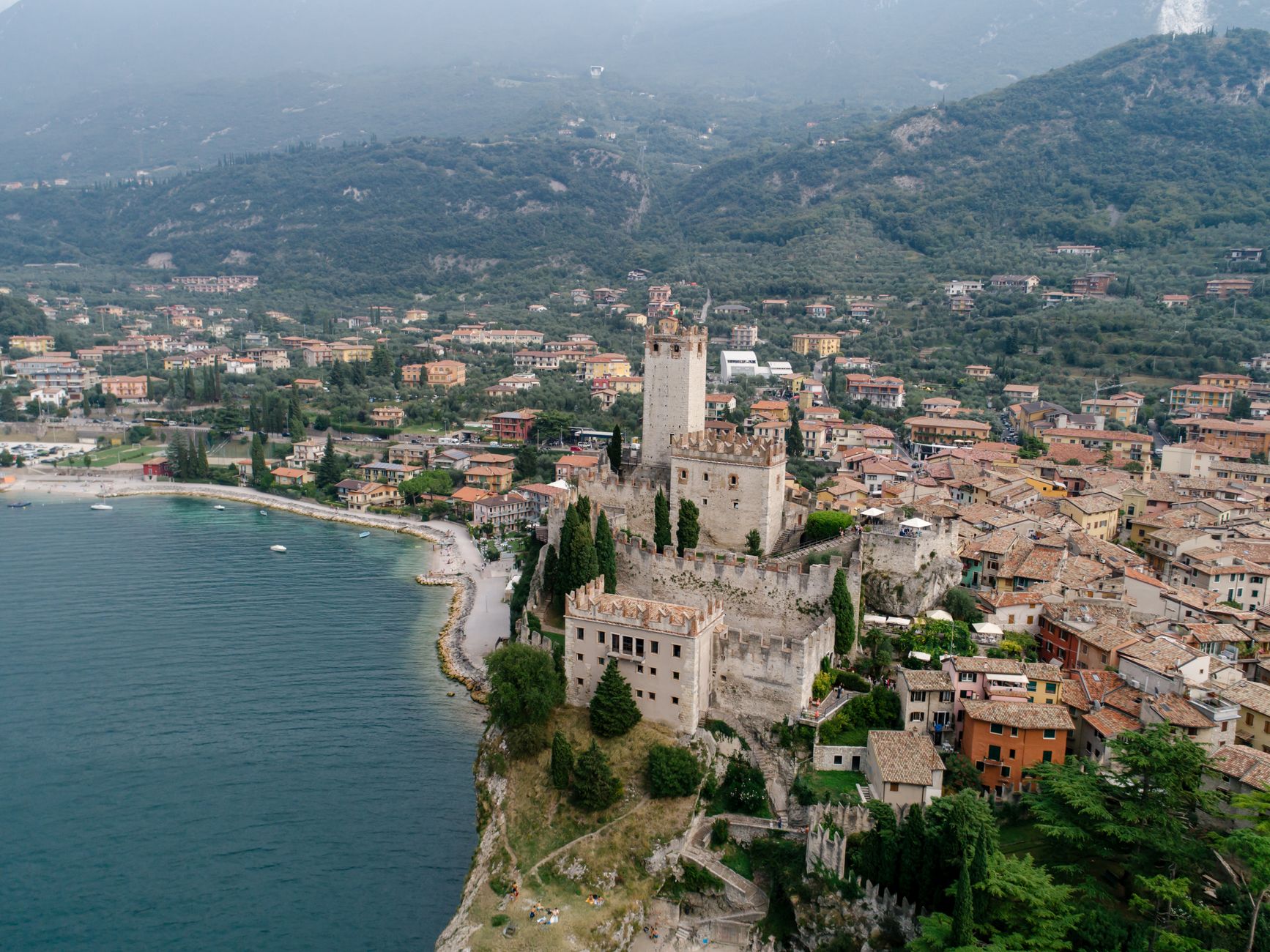 Stunning aerial view of Malcesine Castle, a medieval fortress by Lake Garda, Italy.