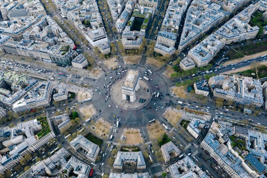 Breathtaking aerial image of Arc de Triomphe nestled within Paris's vibrant cityscape.