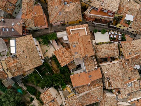 Aerial view of a Mediterranean village with terracotta rooftops and narrow streets.