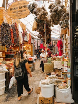 Vibrant spice market scene in Istanbul with bustling shoppers and colorful spices on display.