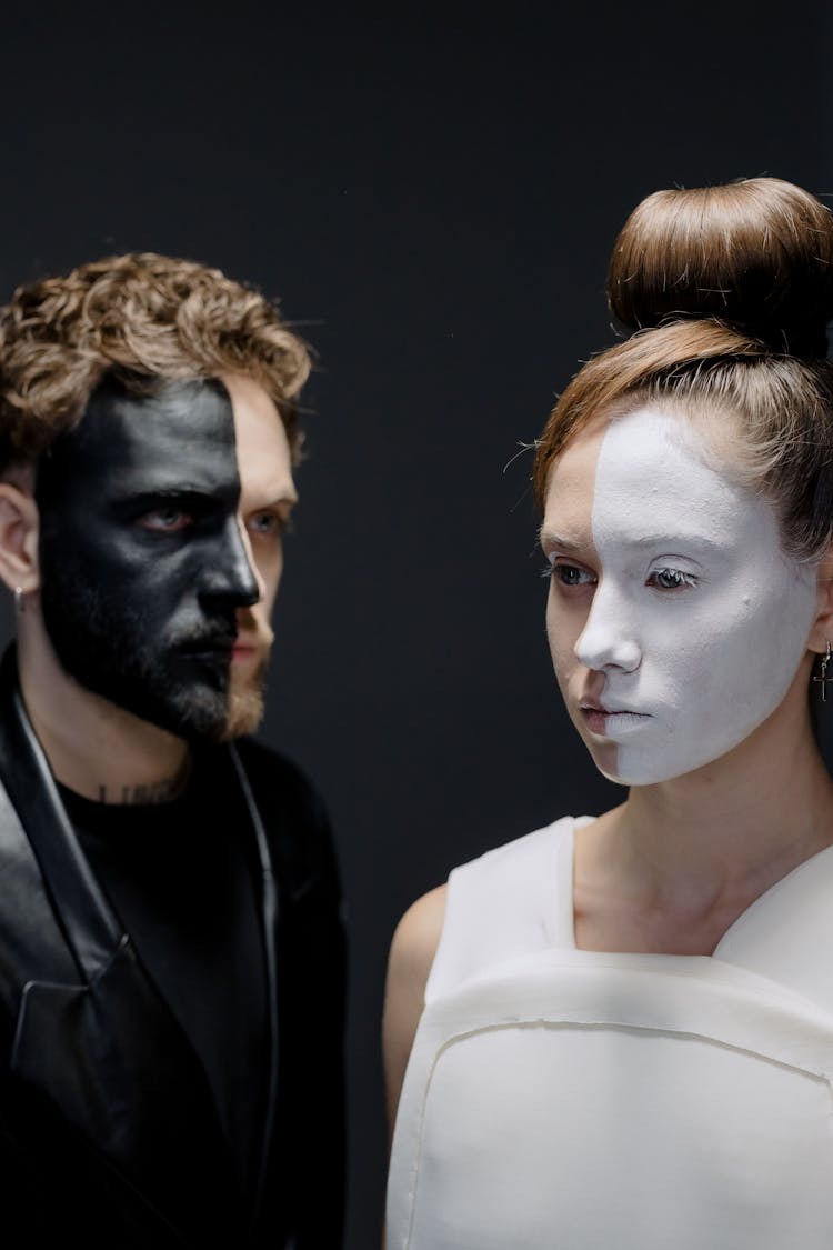 A Woman And A Man Half Face Painted In White And Black