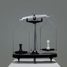 Chess pieces rest in perfect equilibrium on a balance scale, representing strategic equality.