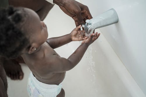 A Child Washing His Hands