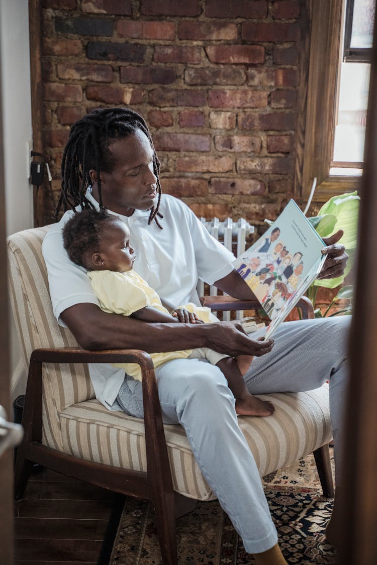 A Father Reading A Book To His Child