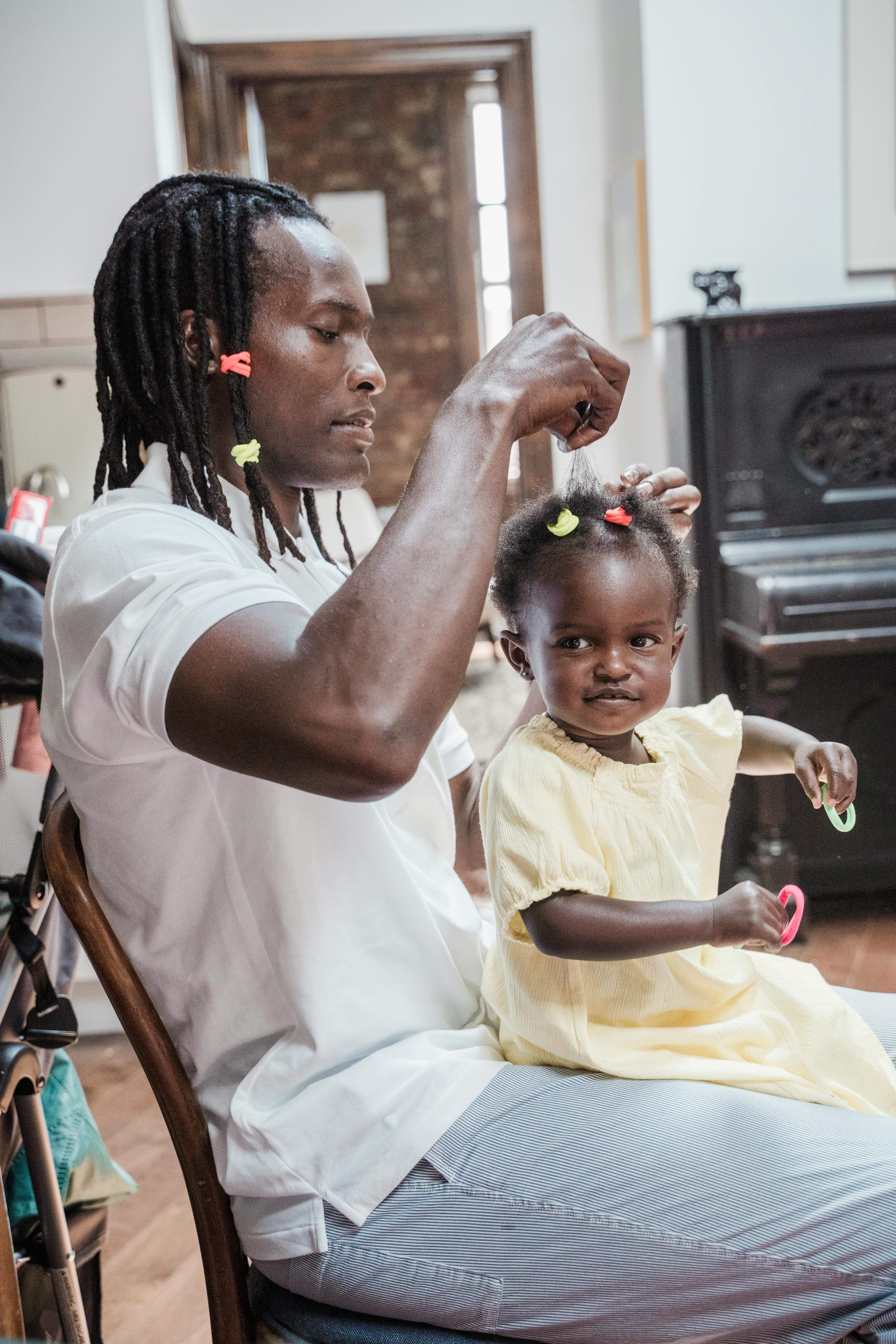 man with his baby daughter sitting on his lap