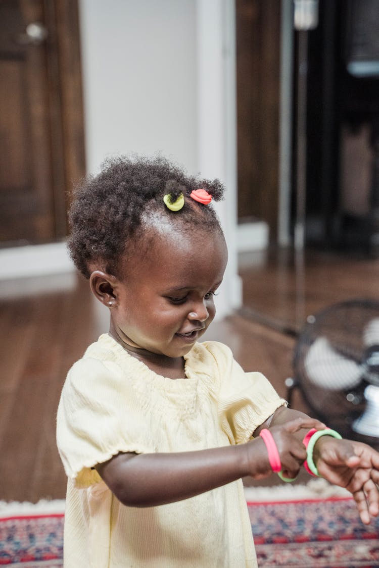 A Girl With Hair Ties On Hair And Wrist