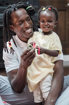 Cheerful Father and Daughter Playing with Hairbands