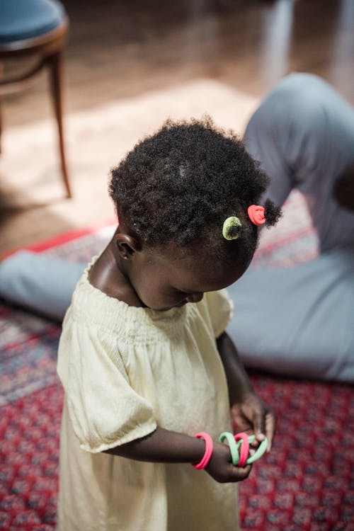 Girl in Dress Playing with Wristbands