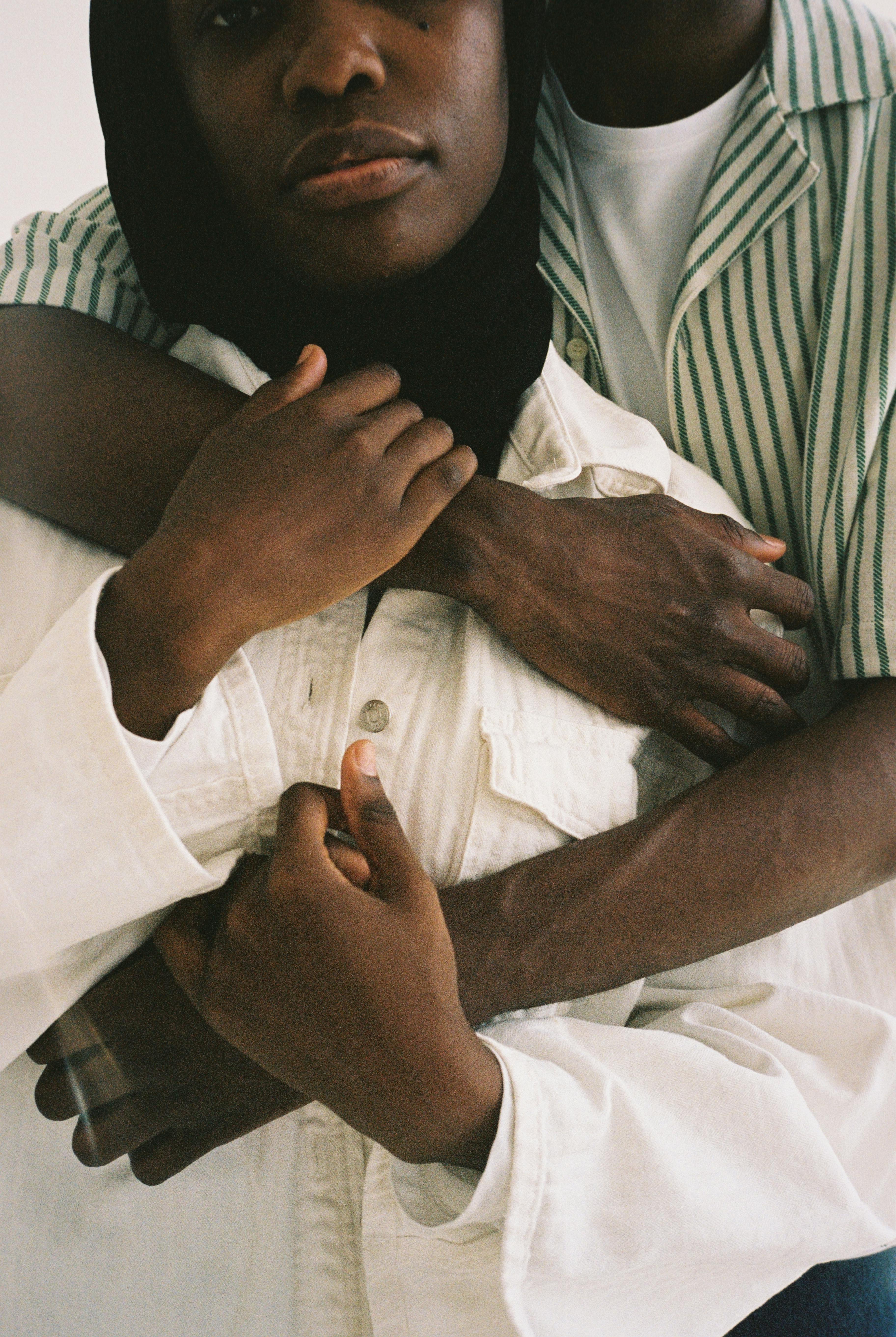 Close-up of two fashionable individuals embracing, capturing love and connection.