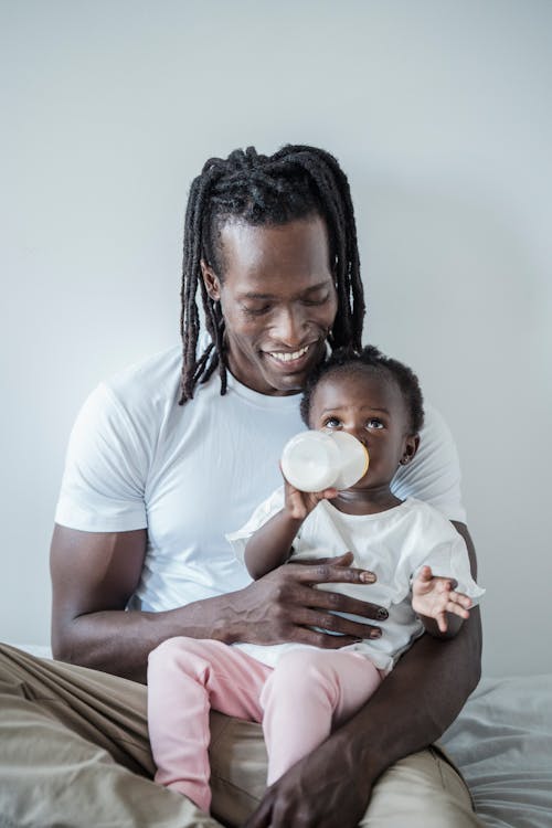 Free A Toddler Drinking Milk from a Baby Bottle Stock Photo