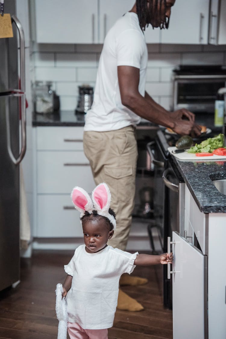 Baby Girl With Bunny Ears Headband Standing Near Her Father