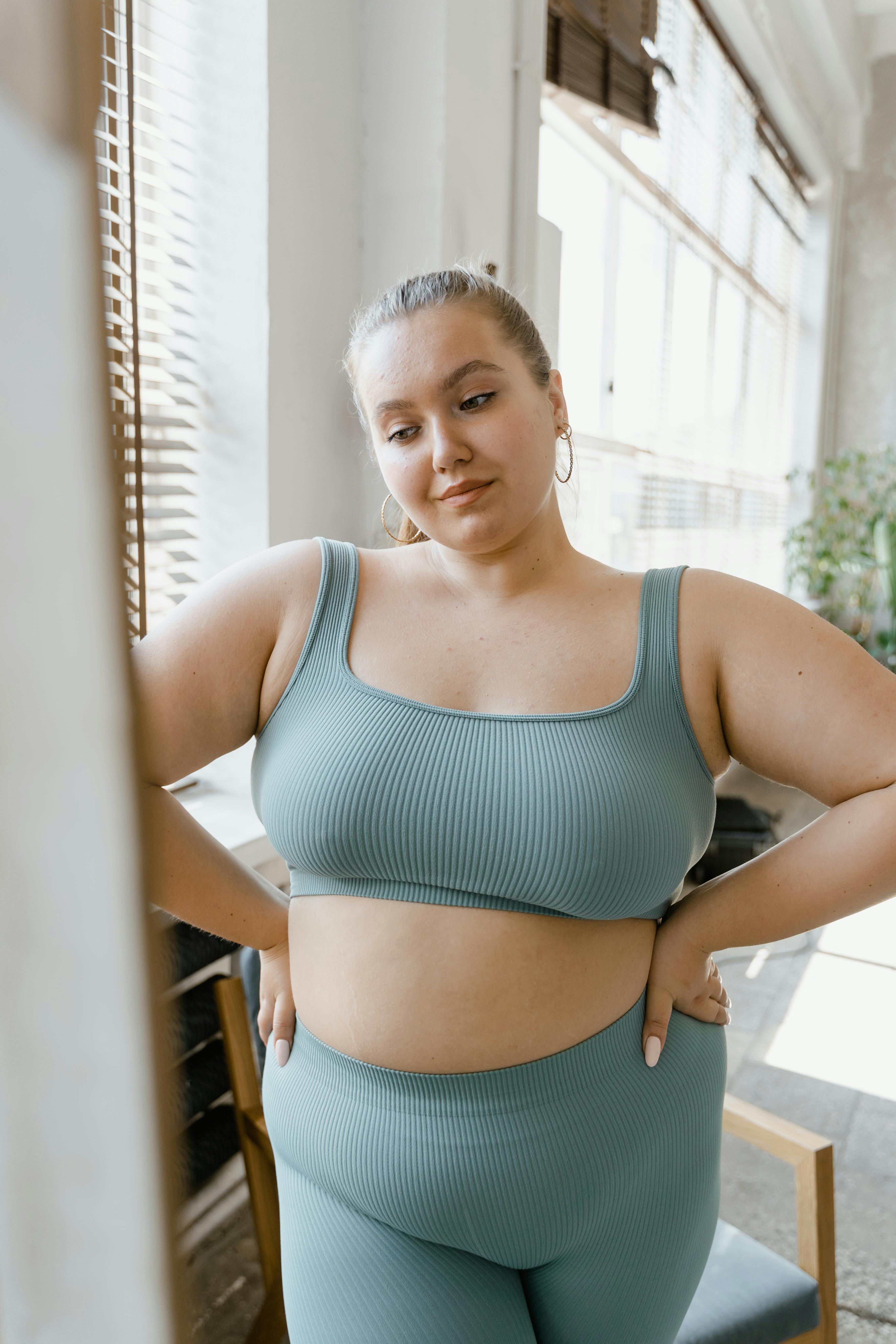 Woman in Teal Sports Bra and Brown Leggings · Free Stock Photo