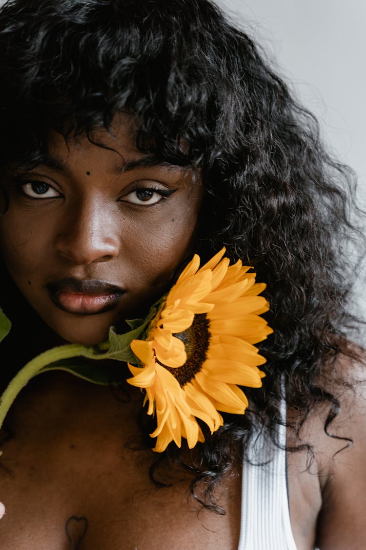 Woman Holding A Sunflower 