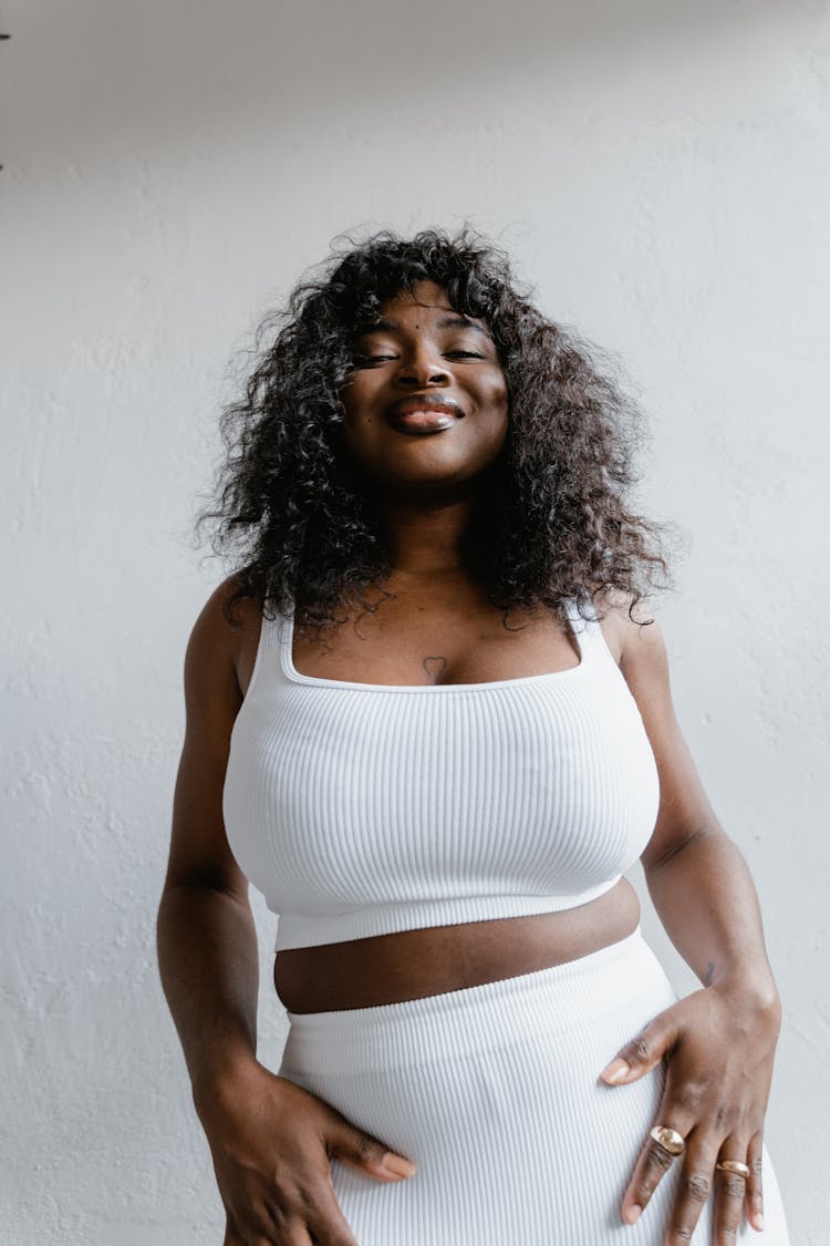 Woman Wearing A White Tank Top Posing