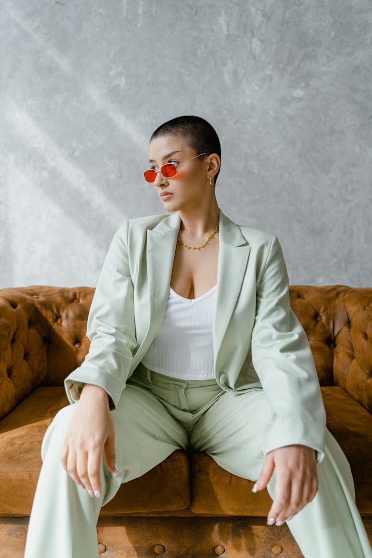 Woman Wearing Blazer Sitting On Sofa