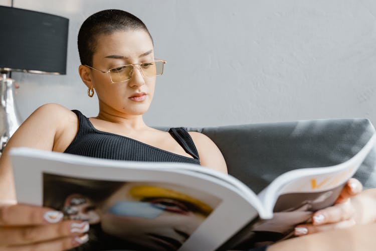 Close Up Photo Of Woman Reading Magazine