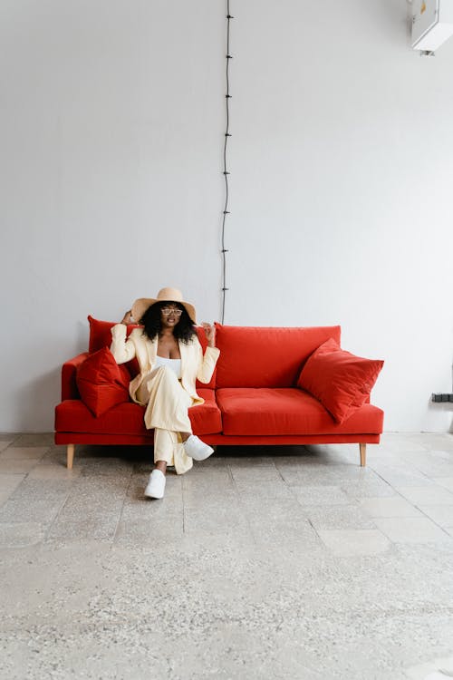 Woman Sitting on a Red Couch