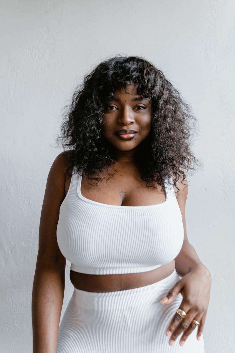 Smiling Woman In White Tank Top And Leggings