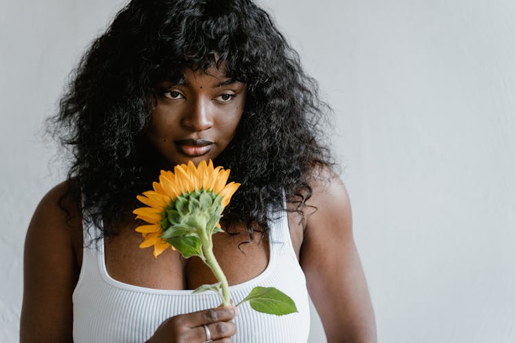 Woman In White Tank Top Holding Yellow Sunflower