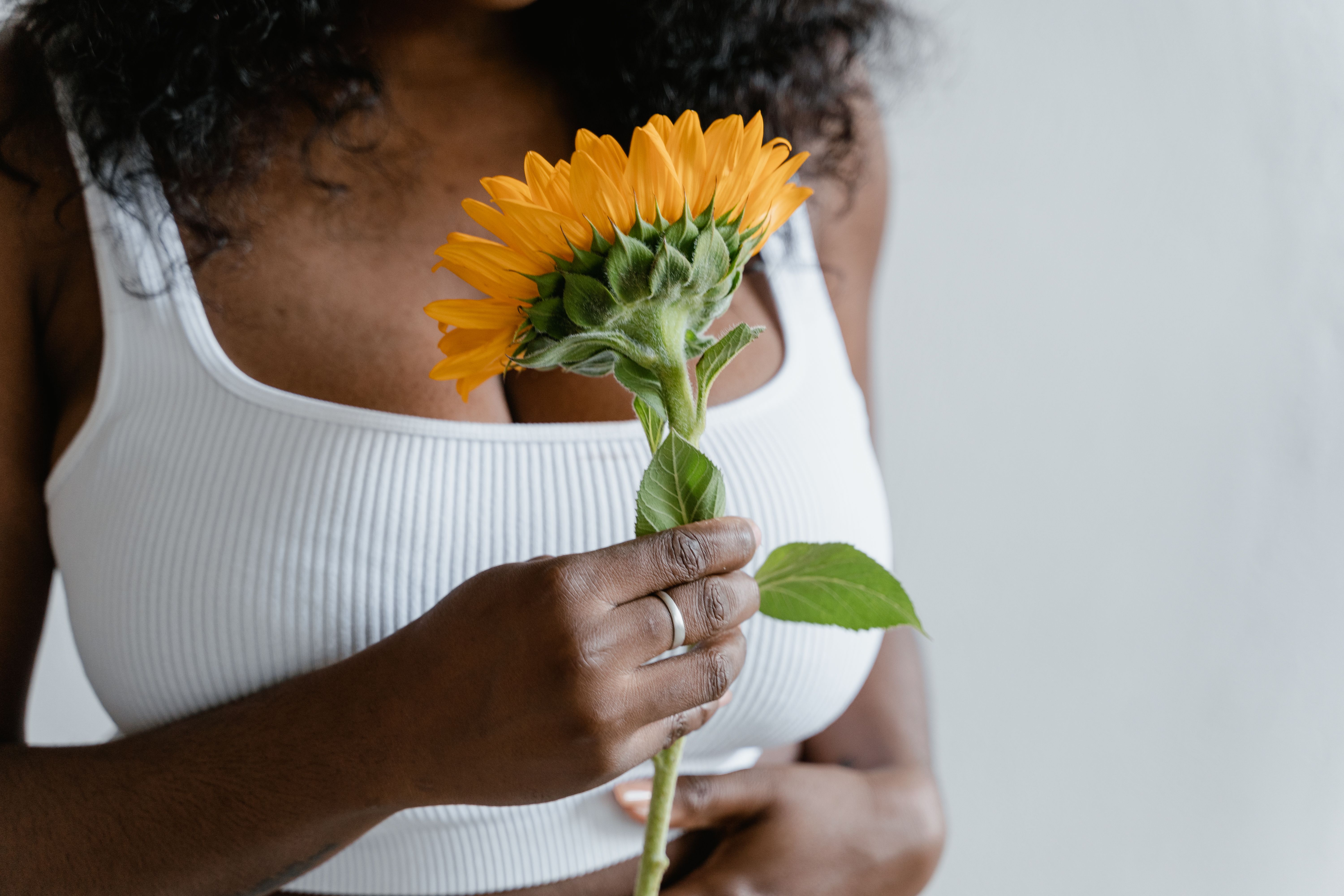 Close-up of Woman Holding a Sunflower · Free Stock Photo