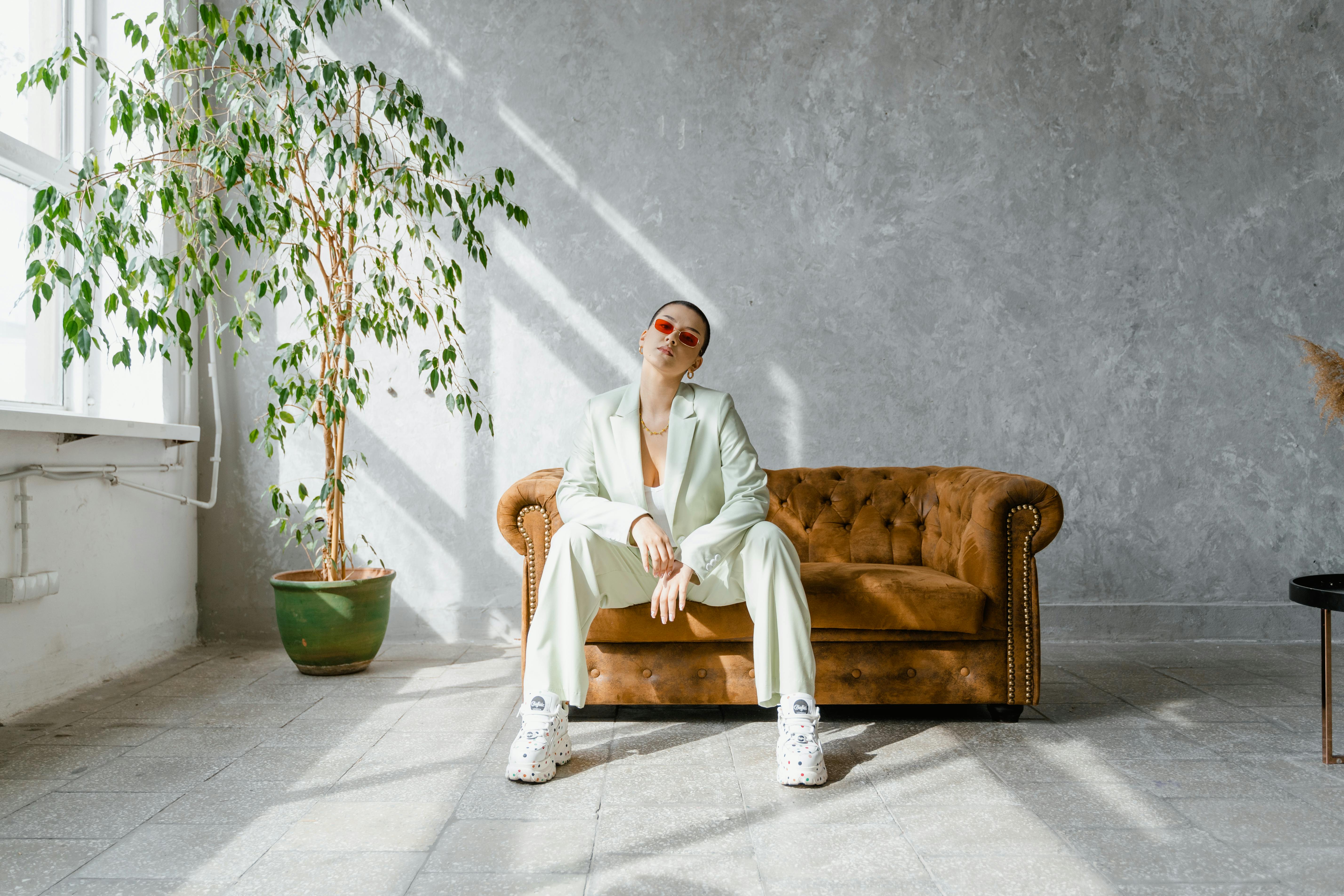 Man in White Robe Sitting on Brown Wooden Armchair · Free Stock Photo