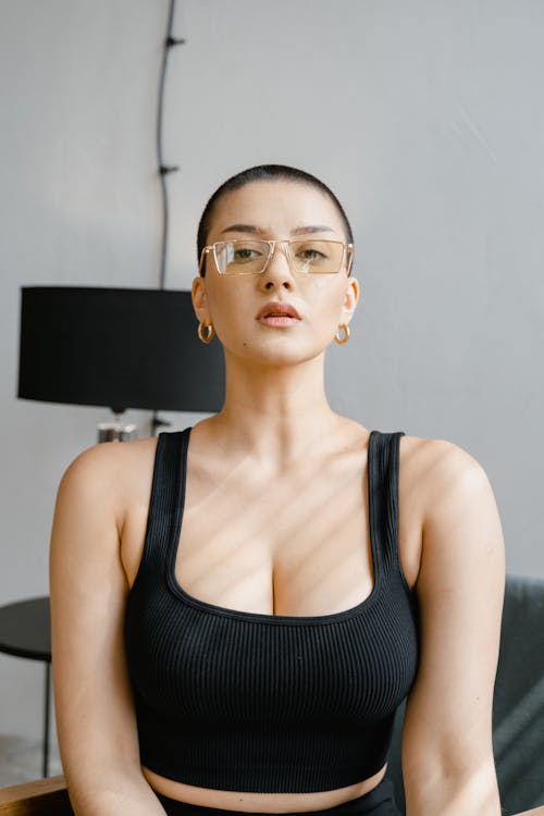 Woman in Black Tank Top Wearing Eyeglasses