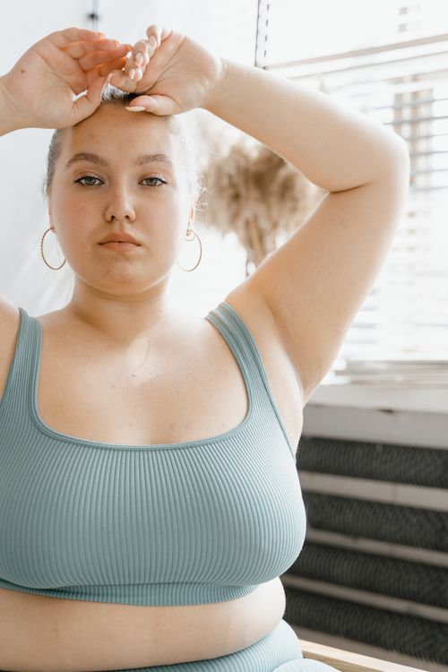 Free A serene portrait of a plus size woman in a teal outfit, embracing body positivity and confidence. Stock Photo