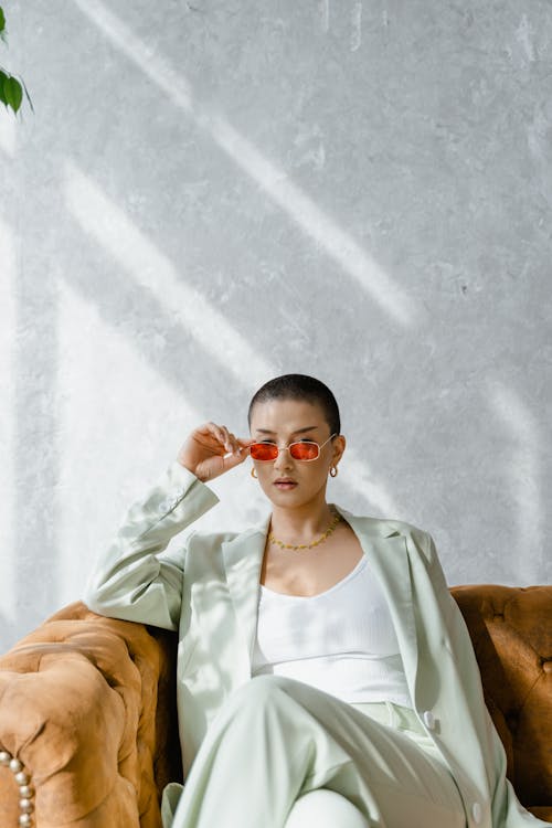 Woman Wearing a Blazer Sitting on a Couch