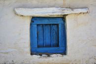 Blue Wooden Window on White Concrete Wall