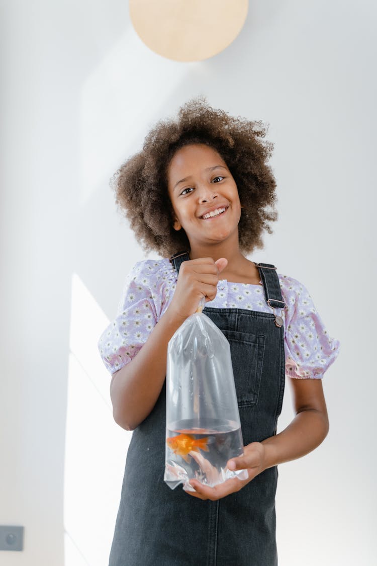 Girl Holding A Plastic Bag With Fish