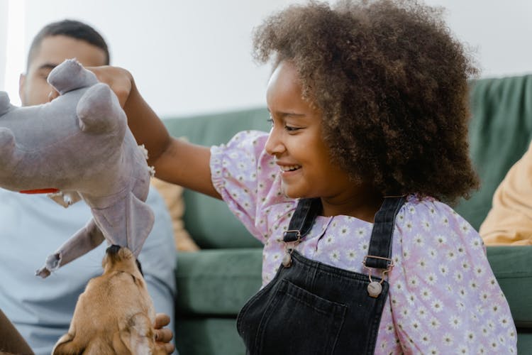 A Girl Playing With A Dog