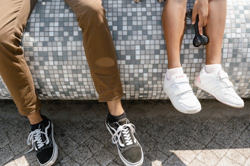 Close Up Shot of Two Person Wearing Sneakers