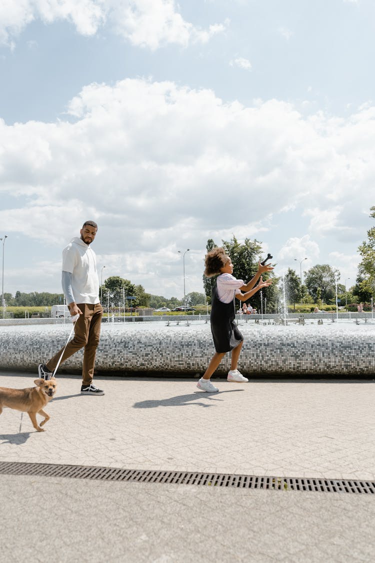 Man And Girl Walking At The Park