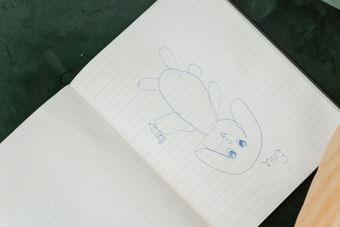 Pen sketch of a cartoon rabbit character in a lined notebook — photo by MART PRODUCTION on Pexels