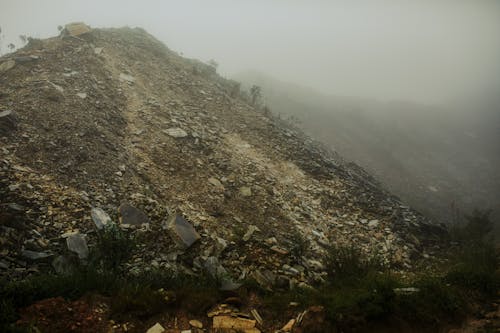 A Gray Rocky Mountain during Foggy Weather