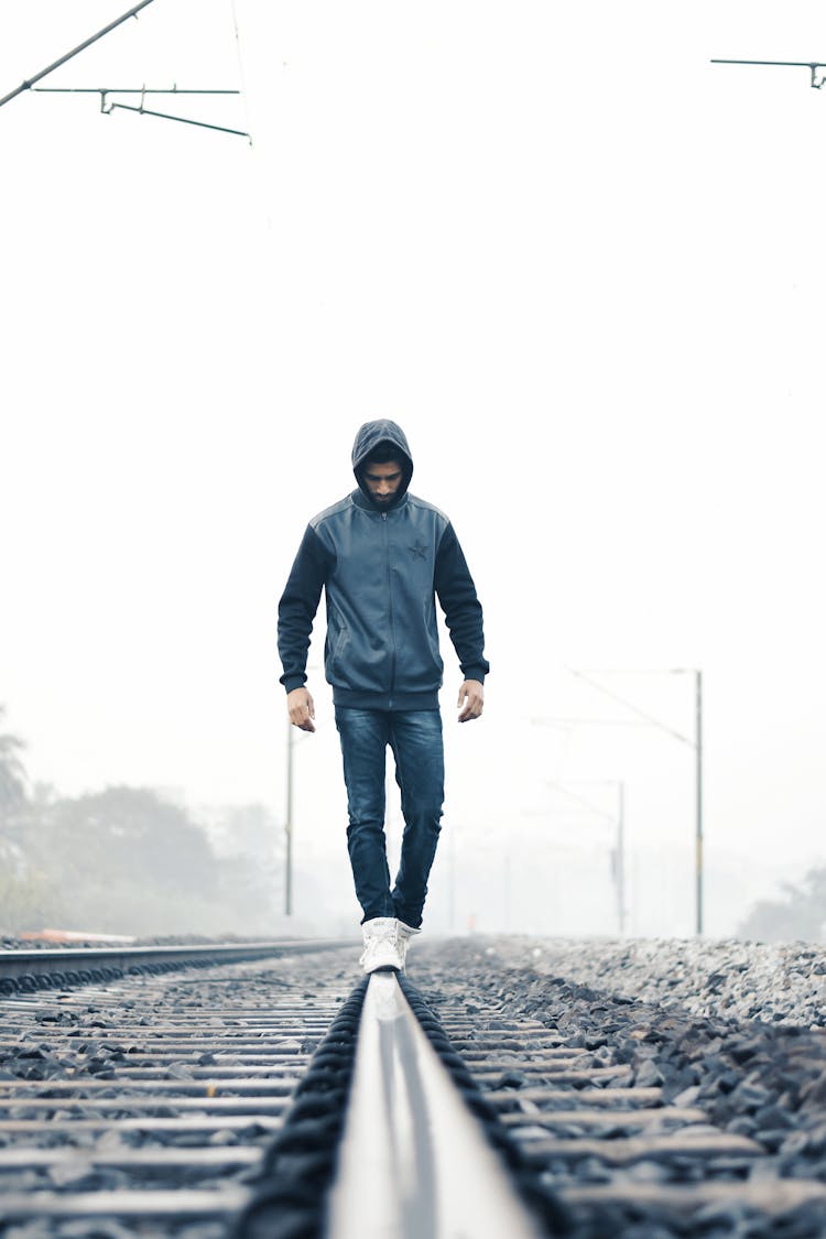 Man Walking On Train Rail