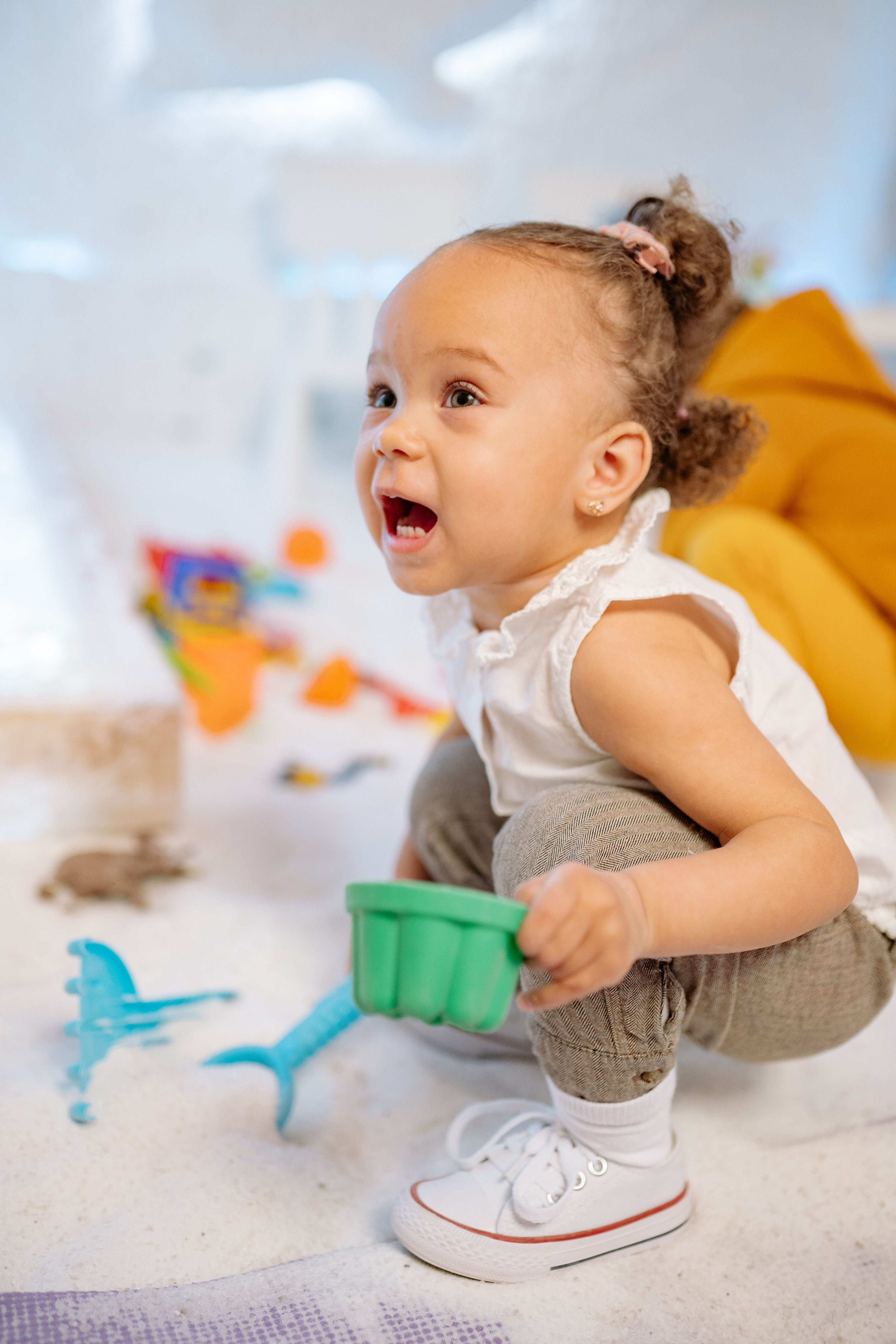 Cute toddler engaged in playful activities with toys indoors, showcasing innocence and joy.
