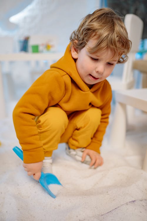 Free Shallow Focus Photo of a Cute Child Playing with Salt Stock Photo