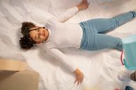 Overhead Shot of a Child Lying Down on Salt
