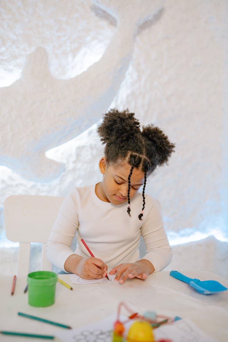 A Girl Coloring Her Artwork