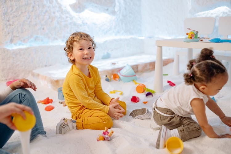 Two Children Playing With Toys